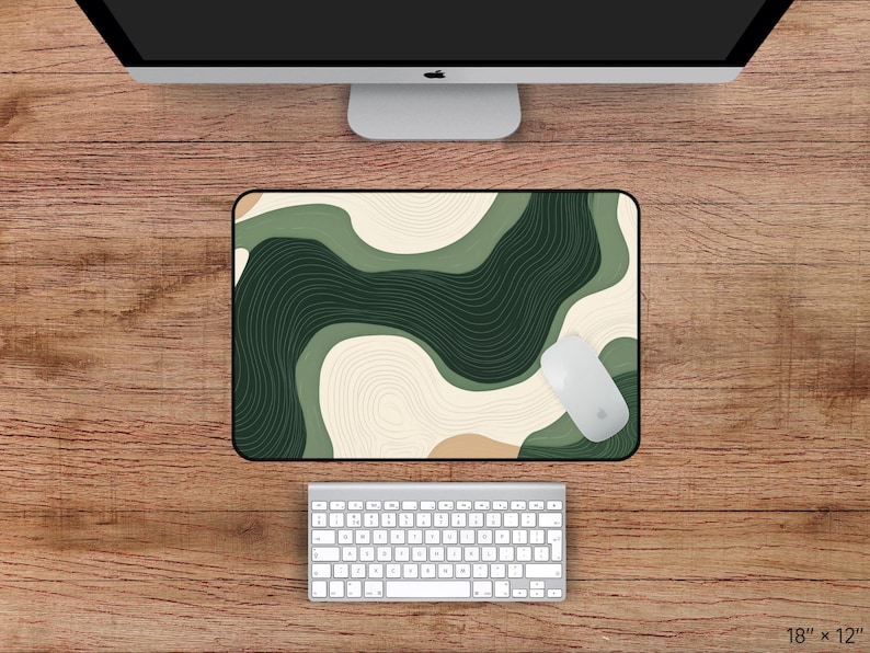 May include: A rectangular mouse mat with a green and beige abstract design, a white mouse, and a white keyboard. The mouse mat measures 45.7 x 30.5 cm.