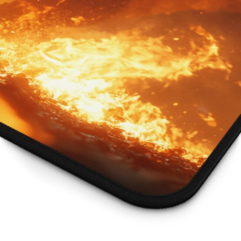 May include: A close-up of a fiery orange and yellow flame with a black border around the edge.