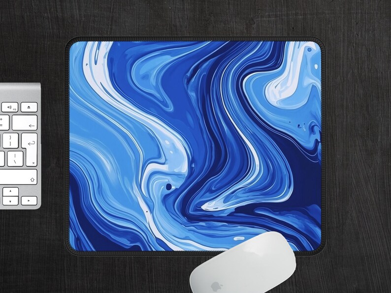 May include: Blue and white abstract marble design mouse pad. The design features swirling, flowing lines of blue and white paint.