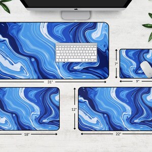 May include: A set of four blue and white marble-patterned mouse pads in various sizes. The largest mouse pad is 31 inches by 15.5 inches, the second largest is 22 inches by 12 inches, the third largest is 18 inches by 12 inches, and the smallest is 9 inches by 7 inches.