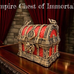 May include: A decorative chest with the text "Vampire Chest of Immortality." The chest has a red interior and is trimmed with gold-colored metal. The chest is sitting on a dark wooden table.