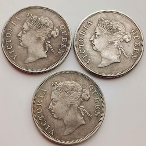 May include: Three antique silver coins displaying a profile of Queen Victoria, with the inscription "VICTORIA QUEEN" around the rim. The coins are circular and show signs of age and wear.