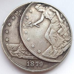 1879 Felaktig omstämning av minnesmyntet med två sidor i handelsdollarn.