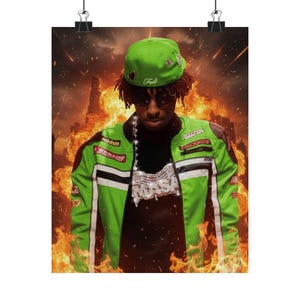 May include: Poster showing a person in a green racing jacket, cap, and diamond pendant, set against a fiery backdrop. The jacket has white stripes and sponsor logos. The cap has the word "Fell" on it.