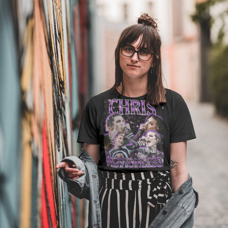 May include: Black t-shirt with a graphic print of a band called "Chris Motionless". The band members are pictured in a black and white photo with a purple and white star background.