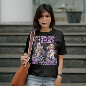 May include: Black t-shirt with a purple and white graphic of a band called "Chris Motionless". The graphic features four band members with a starry background.