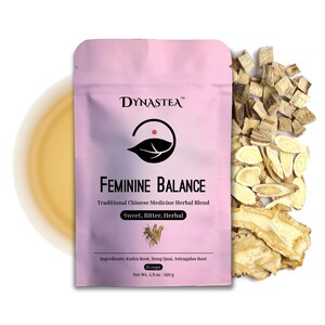 May include: A pink packet of "Feminine Balance" herbal tea by Dynastea. The packet includes the text "Traditional Chinese Medicine Herbal Blend" and "Sweet, Bitter, Herbal." The net weight is 4.9 oz / 140 g. Dried herbs are scattered to the right, and a cup of tea is on the left.