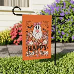 May include: An orange garden flag featuring a white ghost wearing a pink headband and holding a seashell. The ghost is surrounded by various seashells, starfish, and coral. Above the ghost are spiderwebs and bats. The text reads HAPPY Shell-O-Ween.