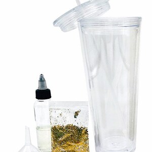 May include: A clear plastic tumbler with a lid and straw, a small bottle of clear liquid, a funnel, and a bag of gold glitter. This is a DIY glitter tumbler kit.