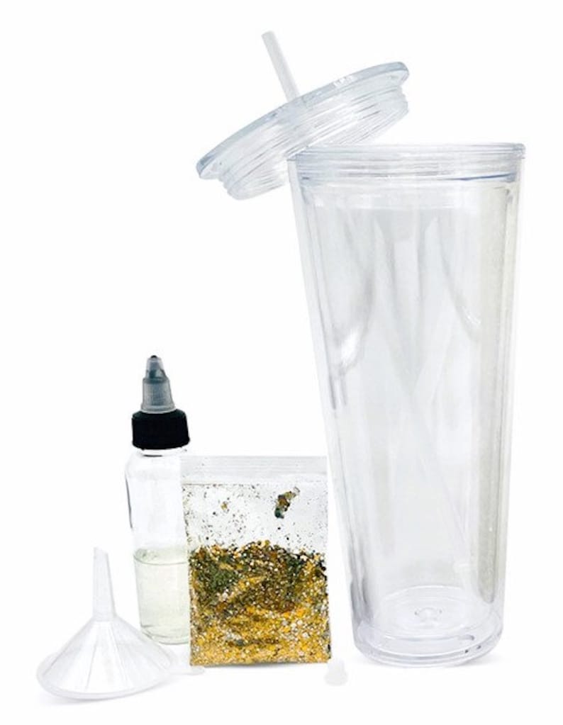 May include: A clear plastic tumbler with a lid and straw, a small bottle of clear liquid, a funnel, and a bag of gold glitter. This is a DIY glitter tumbler kit.