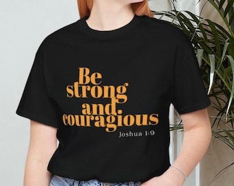 May include: Black t-shirt with the text "Be strong and courageous" in orange letters and "Joshua 1:9" in smaller white letters.