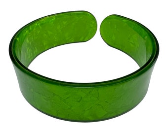 May include: A green plastic bangle bracelet with a marbled effect.