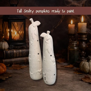 May include: Two tall, white, unpainted ceramic pumpkin figurines with carved stems and leaves. The surfaces feature embossed text reading "Ghoulies and Ghosties and Long-Legged Beasties" and "And Things That Go Bump in the Night!" with small star cutouts.
