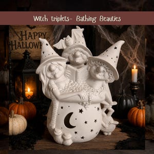 May include: A white ceramic figurine of three witches in a bathtub, with the text "Witch triplets- Bathing Beauties" above. The witches wear pointed hats with star cutouts, and the tub features a crescent moon and star cutouts throughout.