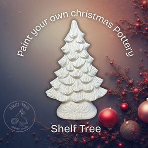 May include: A white ceramic shelf tree with a textured surface, perfect for painting. The image includes the text "Paint your own christmas Pottery" and "Shelf Tree". The Rabbit Tales ceramic studio logo is also visible.