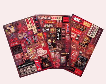 May include: A set of three red and black sticker sheets with Japanese text and images of food, drinks, and other items. The stickers are perfect for adding a touch of Japanese culture to your belongings.