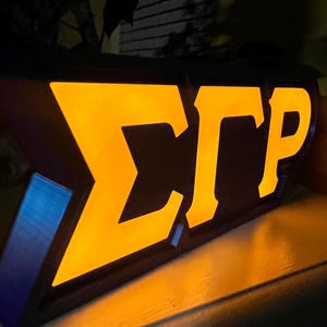 Caixa de luz com letras gregas inspiradas em Sigma Gamma Rho e LED.