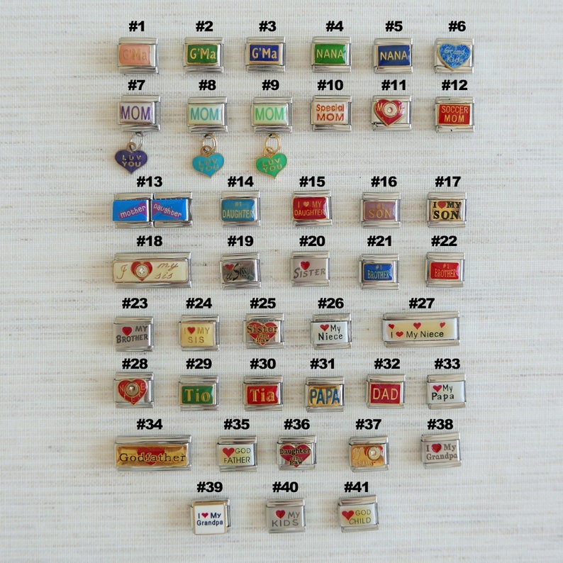 May include: A collection of silver-toned charm beads with various inscriptions, including "Mom," "Sister," and "Grandpa." Some charms feature hearts and colorful accents. The charms are designed for bracelets.