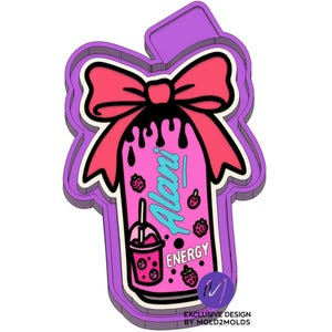 May include: A pink and purple cookie cutter shaped like a can of Alani Nu energy drink with a pink bow on top. The can has a black drip design and says "Alani Nu" and "Energy".