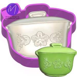 May include: A white and green casserole dish cookie cutter with floral designs. The cookie cutter is in the shape of a casserole dish with a lid and handle. The design includes the text "Original design by MOLD2MOLDS ©2026".