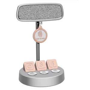 May include: A silver-colored display stand with a rectangular top and a circular base. The stand features a pink "Tap to Pay" tag and three pink square icons with social media symbols. The top has a textured, speckled appearance.