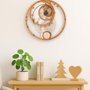 May include: A circular wall clock featuring an intricate exposed gear mechanism made of light-toned wood. The clock face includes a smaller sub-dial at the bottom and a large outer ring. The design showcases mechanical movement with visible gears.
