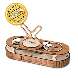 May include: A wooden puzzle featuring a clockwork design with visible gears. The puzzle has a yellow sticker that reads "LIMITED PUZZLE FLOW EDITION". The base of the puzzle is inscribed with "TIME HUNTER" and a Latin phrase.