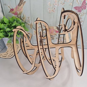 May include: A wooden 3D puzzle in the shape of a sphere. The puzzle is made of interlocking pieces that can be assembled and disassembled. The puzzle is unfinished and has a natural wood color.