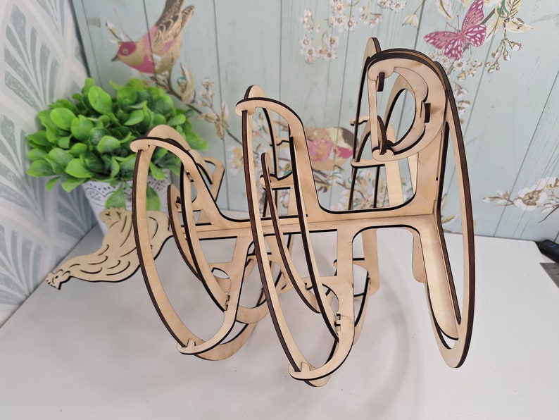May include: A wooden 3D puzzle in the shape of a sphere. The puzzle is made of interlocking pieces that can be assembled and disassembled. The puzzle is unfinished and has a natural wood color.