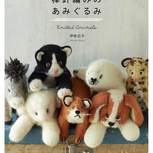 May include: A book cover featuring a collection of knitted animal toys, including a cat, a seal, a dog, a fox, a horse, and a leopard. The title of the book is "棒針編みのあみぐるみ" (Knitted Animals) in Japanese.