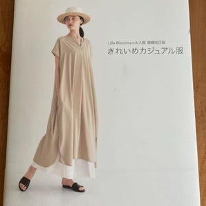 May include: A book cover with a woman wearing a beige dress and a straw hat. The title of the book is "Casual Chic Clothes" and the subtitle is "Lilla Blomma's Adult Clothing Revised Edition: Easy Casual Wear".