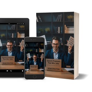 May include: An image of a book, tablet, and smartphone displaying the cover of "Upwork Proposals That Win Jobs" by Dean Stratton. The book is standing upright, while the tablet and phone show the cover image. The background features a man in a suit.