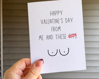 May include: A white greeting card with black text that reads Happy Valentine's Day from me and these censored, featuring a simple black line drawing of two breasts with dots for nipples centered at the bottom of the card.