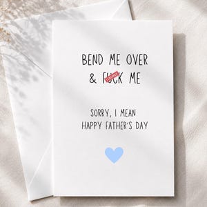 May include: A white Father's Day card with the text "BEND ME OVER & F*CK ME" with a red "CENSORED" stamp over the word "F*CK". The card reads "SORRY, I MEAN HAPPY FATHER'S DAY" with a blue heart. Includes a white envelope.