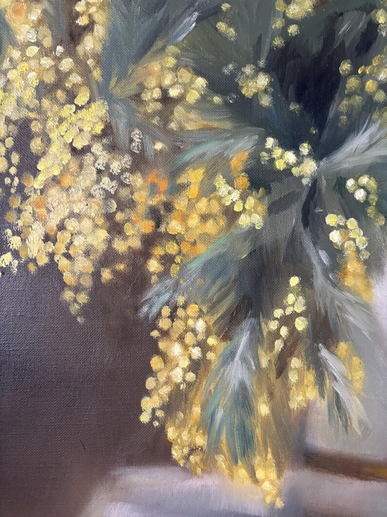 May include: A painting of a bouquet of yellow mimosa flowers with green leaves. The flowers are arranged in a vase, and the background is a dark brown.