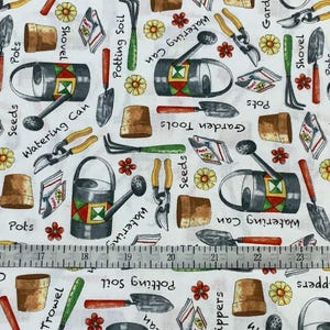 May include: White fabric with a repeating pattern of gardening tools. The design includes watering cans, trowels, shovels, clippers, pots, seed packets, and flowers. The words "Seeds", "Pots", "Clippers", "Garden Tools", and "Potting Soil" are also visible.