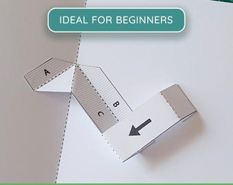 May include: A white paper craft template featuring a teal rectangular label with the text IDEAL FOR BEGINNERS. The template includes folded sections labelled A, B, and C with a black arrow indicating direction. Text at the bottom reads PDF + PNG PRINTABLE TEMPLATE.
