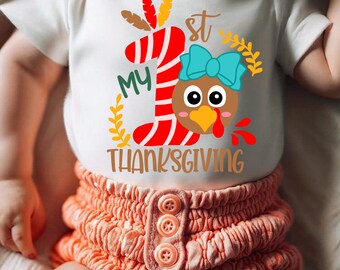 May include: White baby onesie with a red and white striped number one, a turkey with a blue bow, and the text "My 1st Thanksgiving".