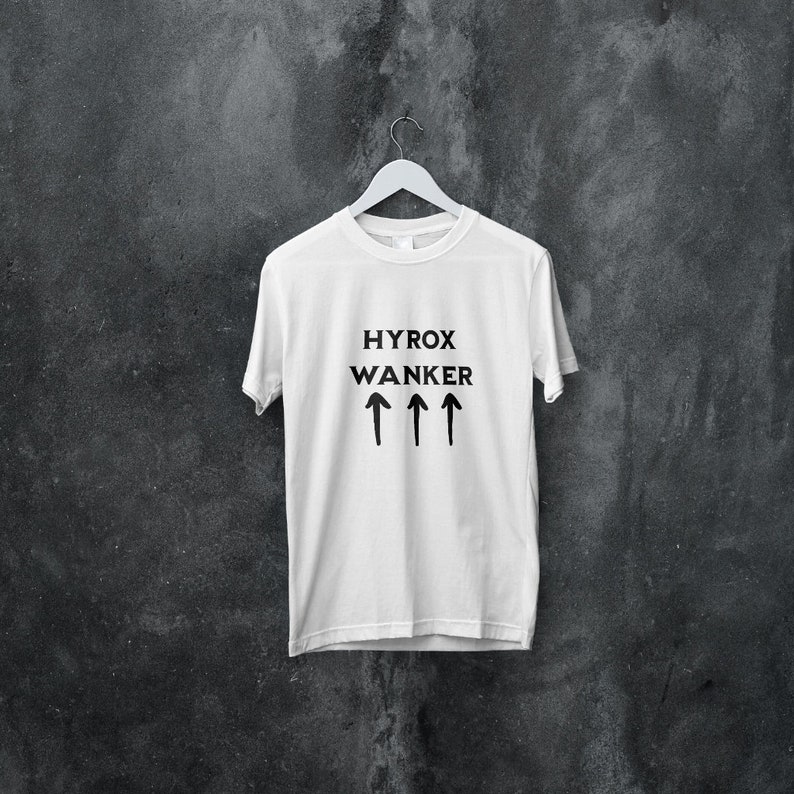 May include: White t-shirt with black text that reads "HYROX WANKER" and four black upward arrows.