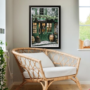 a cozy living room with a wicker chair and a framed picture of a pub with a Guinness sign.