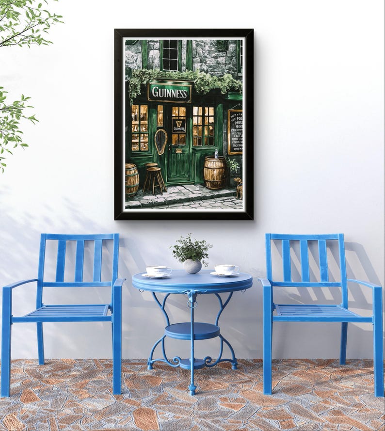 a cozy outdoor seating area with a Guinness pub in the background, complete with a table and chairs. The pub has a green facade and a sign that reads "GUINNESS", creating a warm and inviting atmosphere. The seating area is adorned with two blue chairs, and a small blue table is situated between them. A potted plant is placed on the table, adding a touch of greenery to the scene. The overall setting appears to be a comfortable and relaxing space, perfect for enjoying a pint of Guinness.