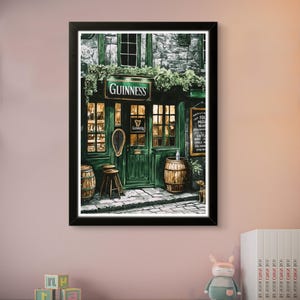 a framed painting of a pub or bar with a Guinness sign, barrels, and a small stuffed animal on a shelf.