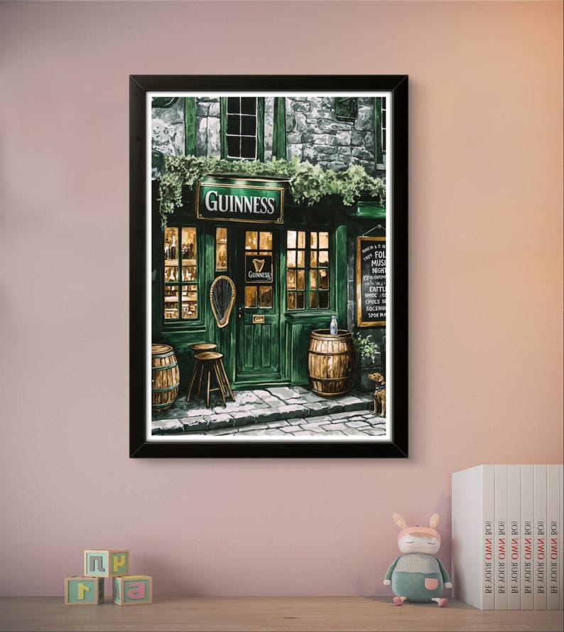 a framed painting of a pub or bar with a Guinness sign, barrels, and a small stuffed animal on a shelf.