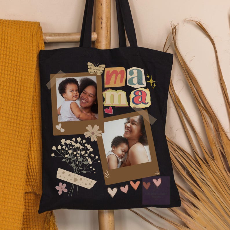 May include: Black tote bag with the word "mama" in colourful letters. The bag features two framed photos of a mother and child, along with decorative elements like hearts, flowers, and a butterfly.