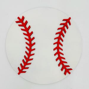 May include: White circular wooden craft with red stitching resembling a baseball.