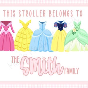 May include: A white card with a pink gingham border features a stroller tag with five princess dresses in pink, yellow, blue, yellow, and green. The text reads "This stroller belongs to the Smith family."