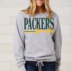 May include: Gray sweatshirt with a green "PACKERS" and yellow "Green Bay" graphic.