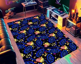 May include: A black and blue area rug with a repeating pattern of film reels and popcorn. The rug is perfect for a movie-themed room.