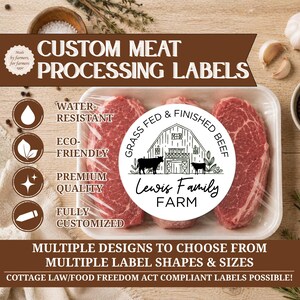 May include: A white circular sticker label featuring a black line drawing of a barn and two cows with the text Grass Fed & Finished Beef and Lewis Family Farm, displayed on a plastic-wrapped tray of three raw red beef steaks on a wooden surface.