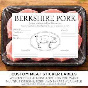 May include: A package of Berkshire pork chops in a black tray, wrapped in clear plastic. A white label reads "BERKSHIRE PORK" with details and a pig illustration. The bottom text says "CUSTOM MEAT STICKER LABELS".